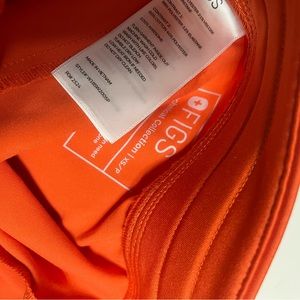 Figs orange Zamora scrub pants.